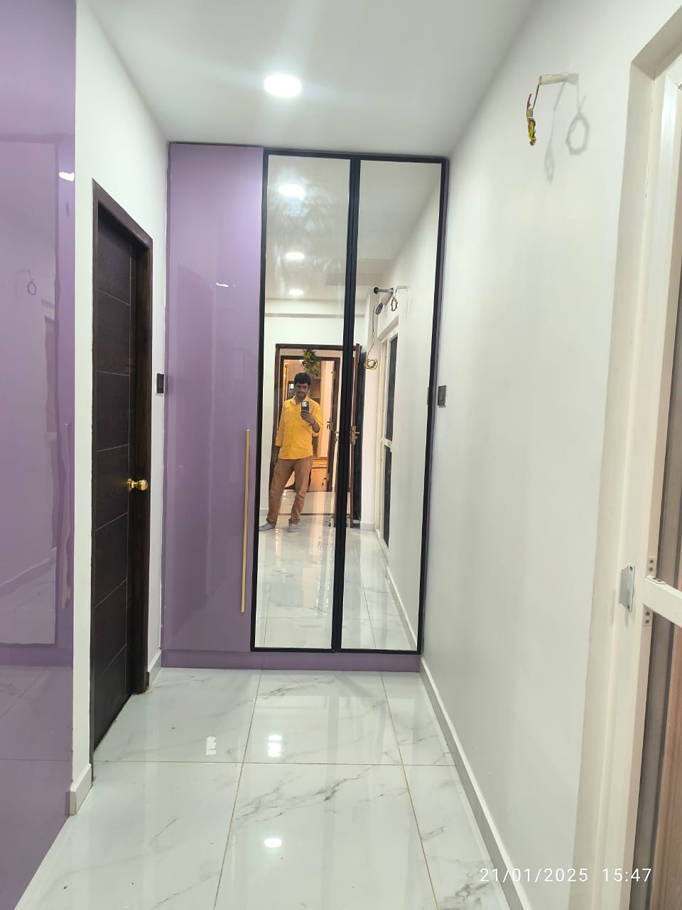 Corridor with purple wardrobe and mirror