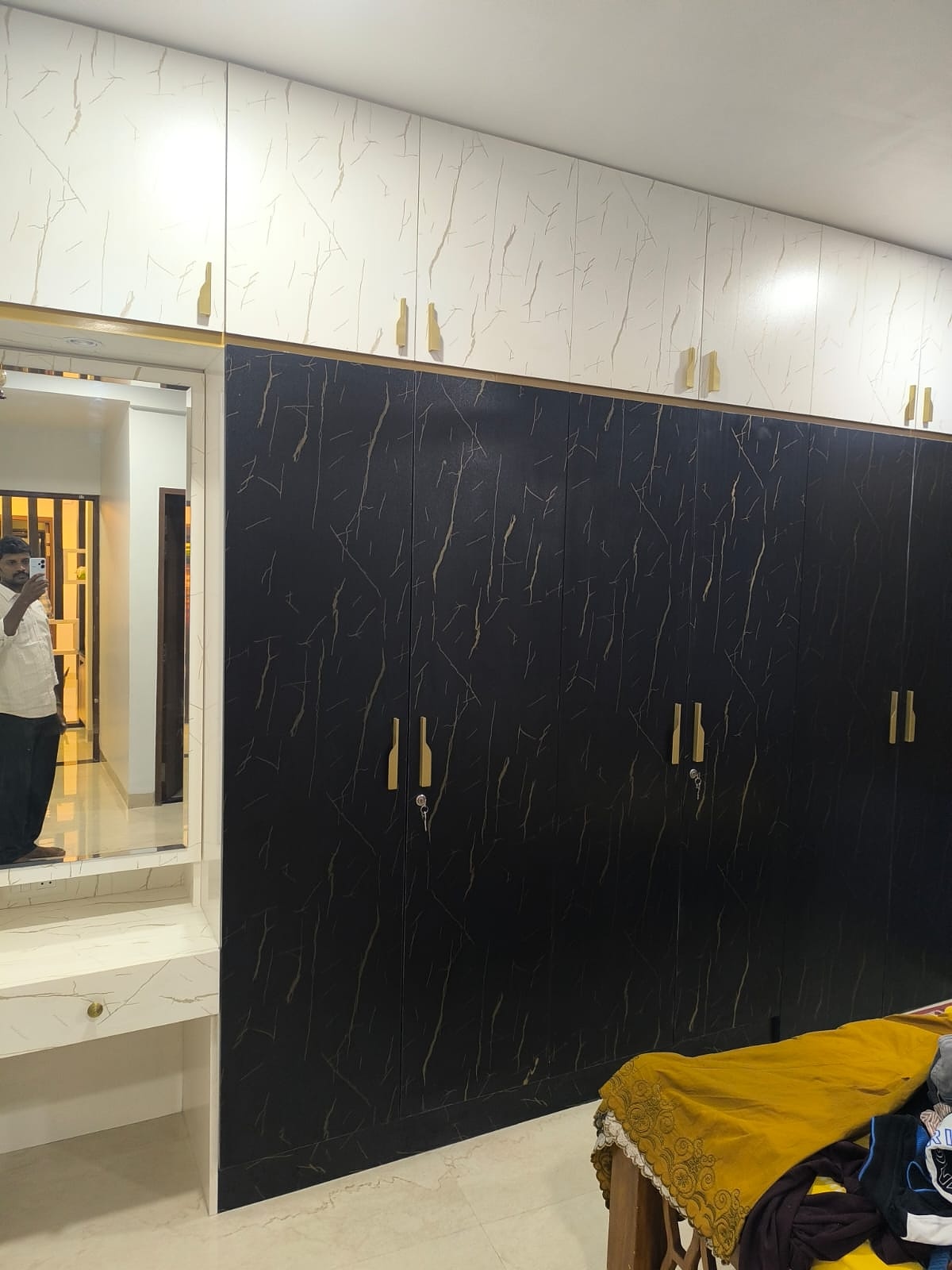 Black marble wardrobe with gold handles
