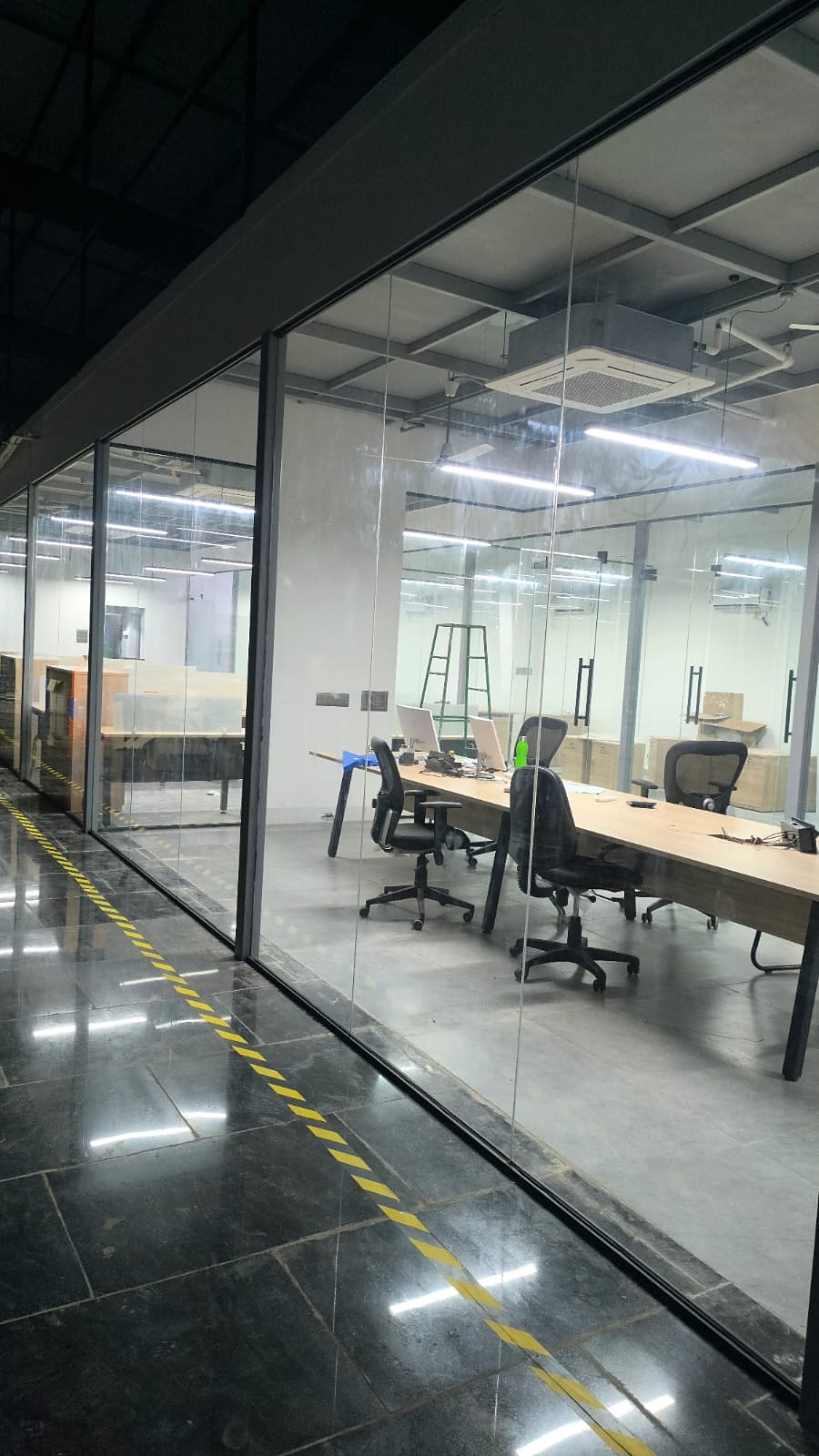 Glass-walled conference room in warehouse-style office