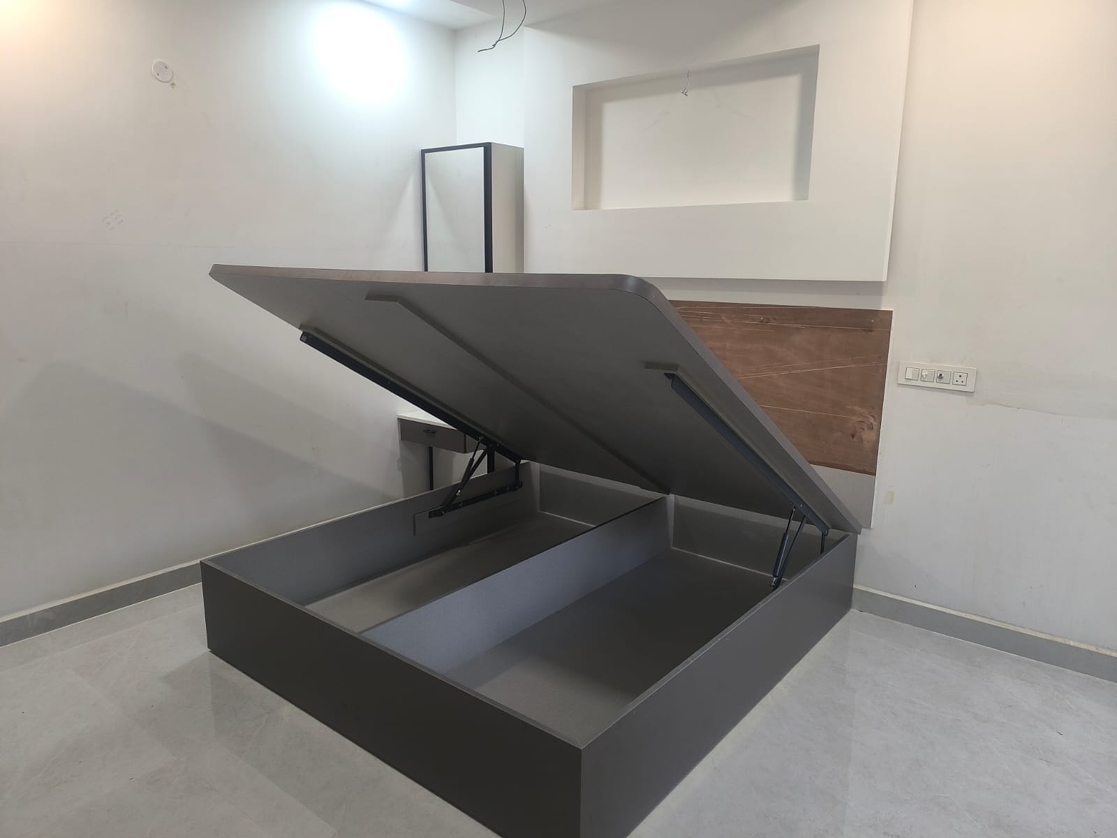 Bed with lift-up storage mechanism
